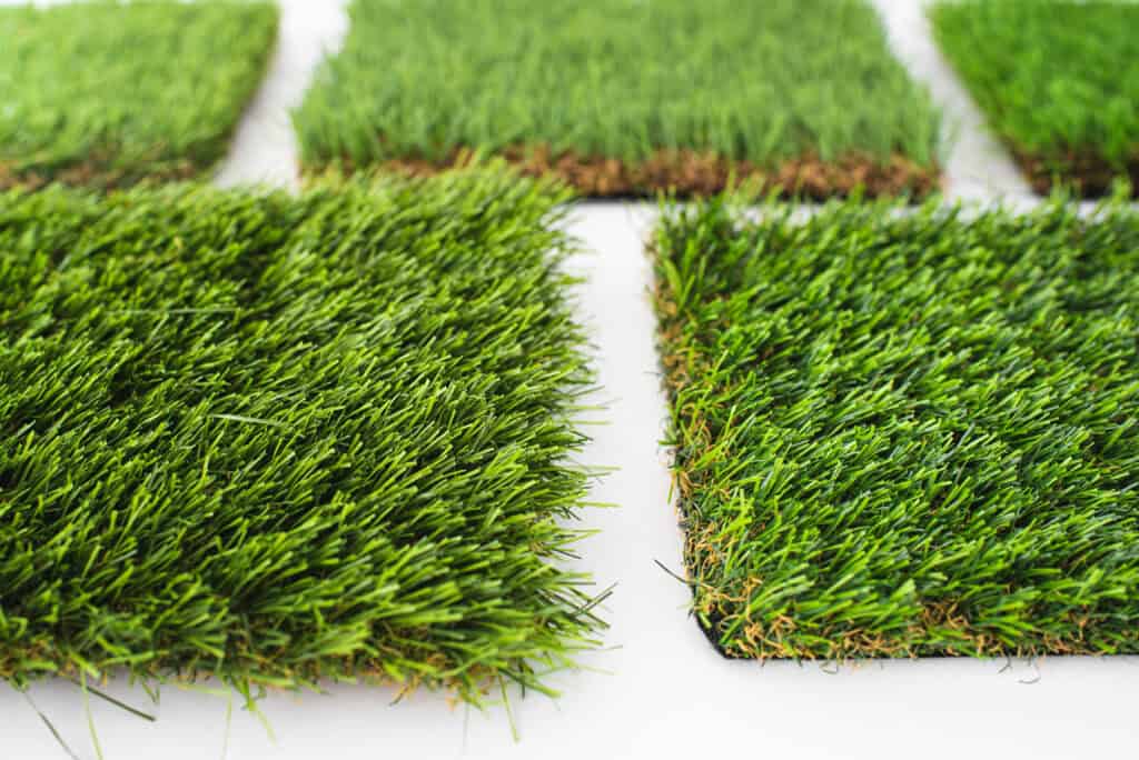 Artificial grass turf close-up, showcasing realistic texture and vibrant green color, ideal for landscaping, outdoor patios, and putting greens. Perfect for low-maintenance yard upgrades.